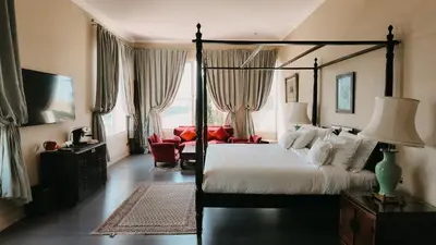 a bedroom with a large bed and a living room at Villa Soraya Lodge & Spa in Rabat