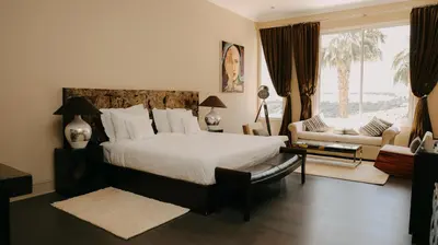 a bedroom with a bed and a large window at Villa Soraya Lodge & Spa in Rabat