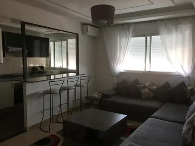 a living room with a couch and a table at DaliMAR in Bouznika