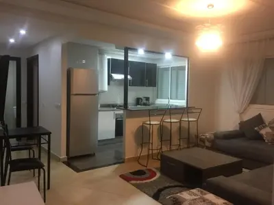 a living room with a couch and a kitchen at DaliMAR in Bouznika