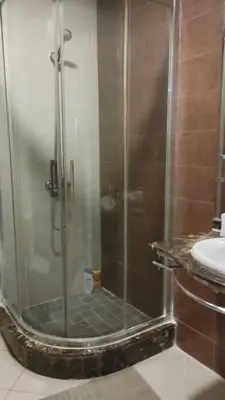 a shower with a glass door in a bathroom at Cozy Studio in Casablanca , 1 km from Casavoyageurs station , Free parking in Casablanca
