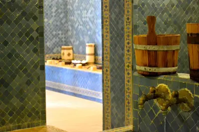 a room with a tile wall with a table and a mirror at Casablanca Le Lido Thalasso & Spa (ex Riad Salam) in Casablanca