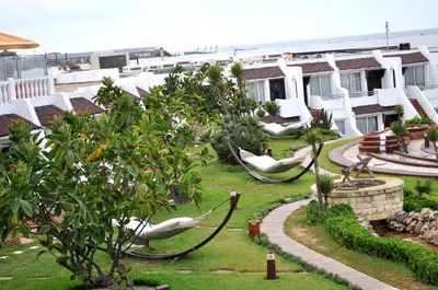 a resort yard with hammocks and trees and buildings at Casablanca Le Lido Thalasso & Spa (ex Riad Salam) in Casablanca