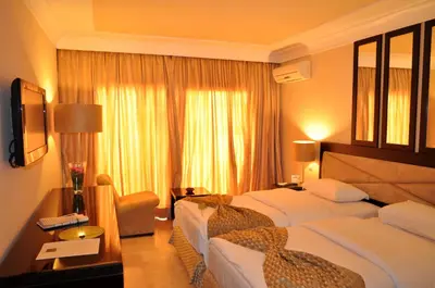 a hotel room with two beds and a window at Casablanca Le Lido Thalasso & Spa (ex Riad Salam) in Casablanca