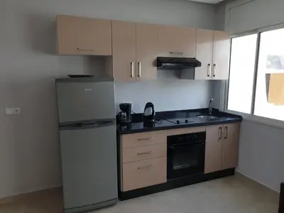 a kitchen with a refrigerator and a stove top oven at Residence Davos Rabat in Rabat