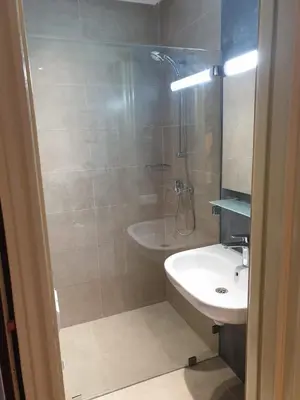a bathroom with a sink and a shower and a toilet at Residence Davos Rabat in Rabat