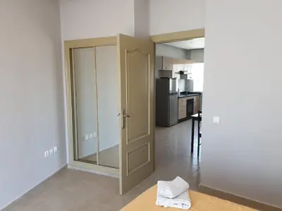a room with a sliding glass door and a kitchen at Residence Davos Rabat in Rabat