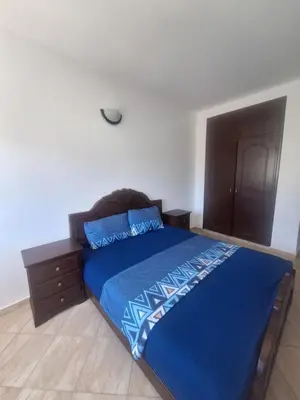 a bedroom with a blue bed and a dresser at Apartment in the city center, 2 minutes walk from the tram in Rabat