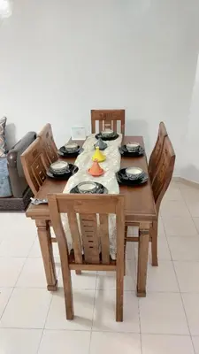 a wooden table with chairs and a table cloth on it at Apartment in the city center, 2 minutes walk from the tram in Rabat