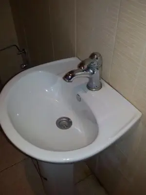 a white sink in a bathroom next to a toilet at Agdal Two-Bedroom Apartment 2 Minutes from Agdal Train Station in Rabat