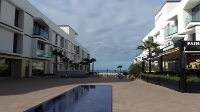 a building with a swimming pool in the middle of a street at Anfa Place in Casablanca