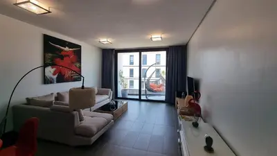 a living room with a couch and a tv at Anfa Place in Casablanca