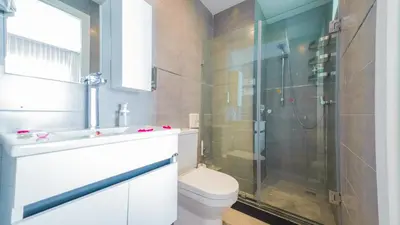 a bathroom with a shower and a toilet and a sink at RENT-INN Suites Hotel in Rabat