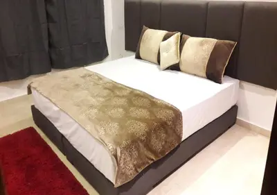 a bedroom with a large bed with a black headboard at Horizon Home in Casablanca
