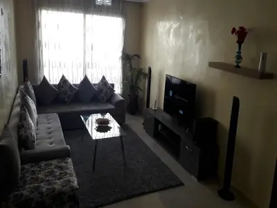 a living room with a couch and a tv at Horizon Home in Casablanca