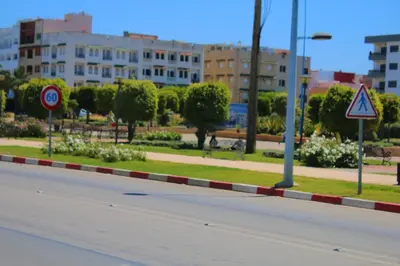 an empty street with buildings in the background at Jnane Eddalya in Bouznika