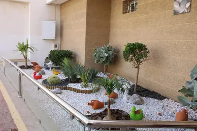 a miniature garden in a building with trees and plants at Jnane Eddalya in Bouznika