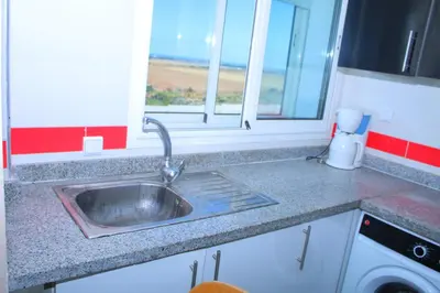 a kitchen counter with a sink and a window at Jnane Eddalya in Bouznika