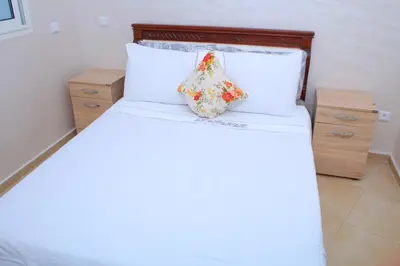 a bed with a pillow sitting on top of it at Jnane Eddalya in Bouznika