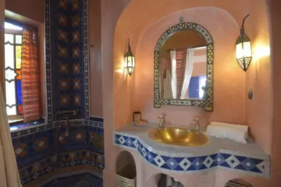 a bathroom with a sink and a mirror at Riad Des Plages in Bouznika