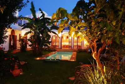 a house with a swimming pool in the yard at Riad Des Plages in Bouznika