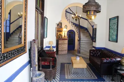 a living room with a couch and a table at Hôtel Central in Casablanca