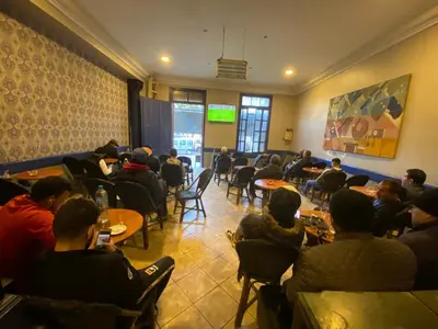 a group of people sitting at tables in a room at Hôtel Central in Casablanca