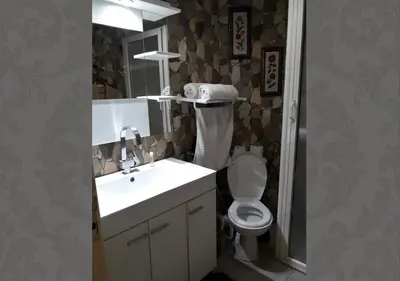 a bathroom with a sink and a toilet and a mirror at Studio les Belles Residences in Casablanca