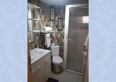 a bathroom with a toilet and a shower and a sink at Studio les Belles Residences in Casablanca