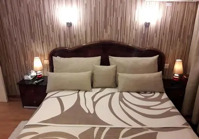 a bedroom with a large bed with pillows and two lamps at Studio les Belles Residences in Casablanca