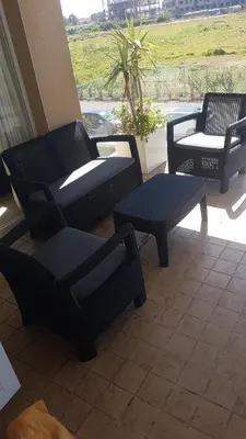 a group of chairs and tables on a porch at Evasion Bouznika أمام شاطىء بوزنيقة in Bouznika