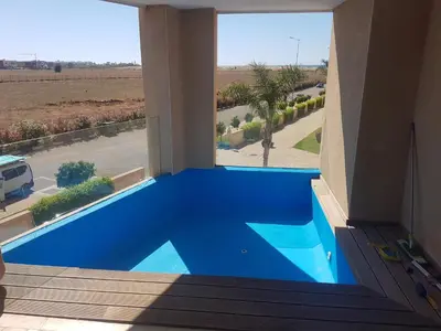 a swimming pool in a house with a view of a street at Evasion Bouznika أمام شاطىء بوزنيقة in Bouznika