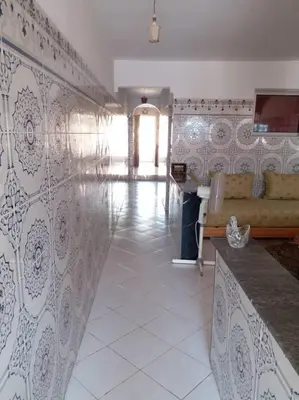 a living room with a couch and a tile floor at Villa Close To The Beach in Temara