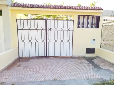 an open gate to a house with at Villa Close To The Beach in Temara