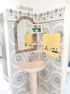 a bathroom with a sink and a mirror at Villa Close To The Beach in Temara