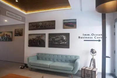 a living room with a blue couch on a wall at Ocean Park Hotel, Premium Suites & Wellness in Casablanca