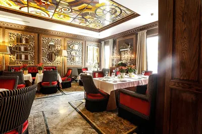a dining room with tables and chairs and a ceiling at Hôtel particulier Le DOGE - Relais & Châteaux in Casablanca