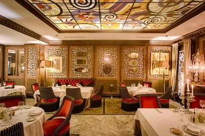 a restaurant with tables and chairs and a ceiling at Hôtel particulier Le DOGE - Relais & Châteaux in Casablanca