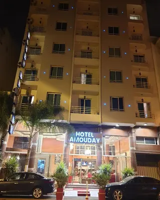 a hotel at night with cars parked in front of it at Hôtel Amouday in Casablanca
