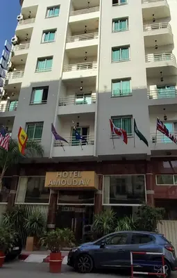 a car parked in front of a hotel administration building at Hôtel Amouday in Casablanca