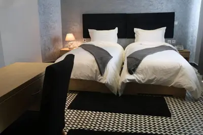 a bedroom with two beds and a desk at Point du Jour in Casablanca