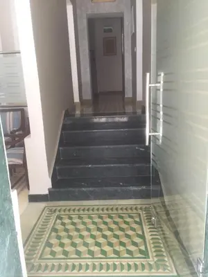 a hallway with stairs with a checkered floor at Point du Jour in Casablanca