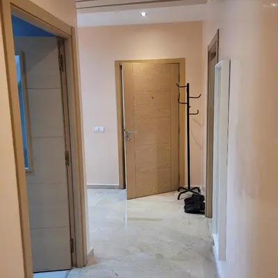 a hallway with a door in a room with a tile floor at Herb studio in Casablanca (800 m from Casavoyageurs station) in Casablanca