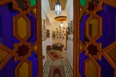 an entrance to a room with a blue door at Riad Alhambra in El Harhoura