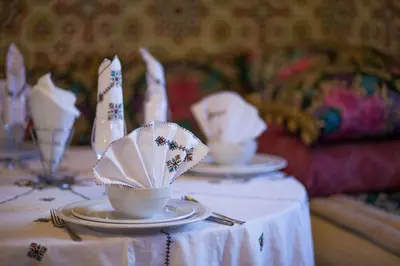 a table with plates and cups on top of it at Riad Alhambra in El Harhoura