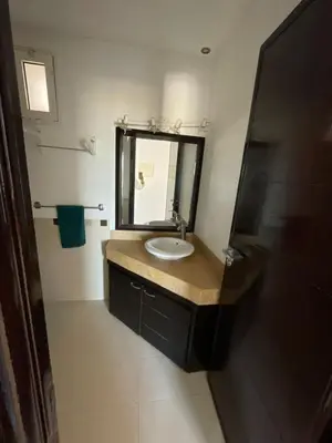 a bathroom with a sink and a mirror at Les perles de tamaris dar bouazza in Dar Mohammed Ould Haj Jilali