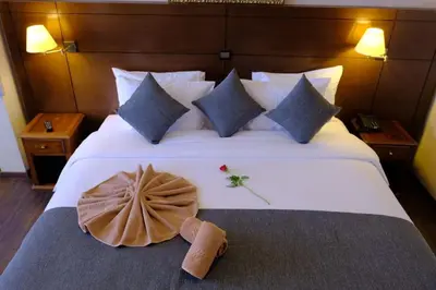 a hotel room with a large white bed with pillows at Washington Hotel in Casablanca
