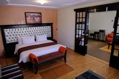 a bedroom with a large bed and a chair in it at Washington Hotel in Casablanca