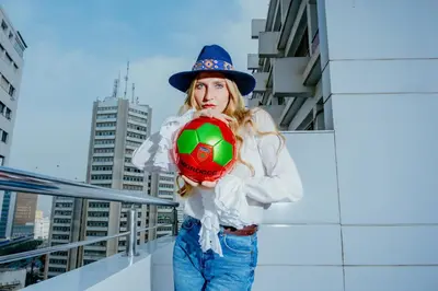 a woman in a hat holding a soccer ball at Oum Palace Hotel & Spa in Casablanca