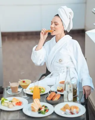 a chef eating food at a table with plates of food at Oum Palace Hotel & Spa in Casablanca